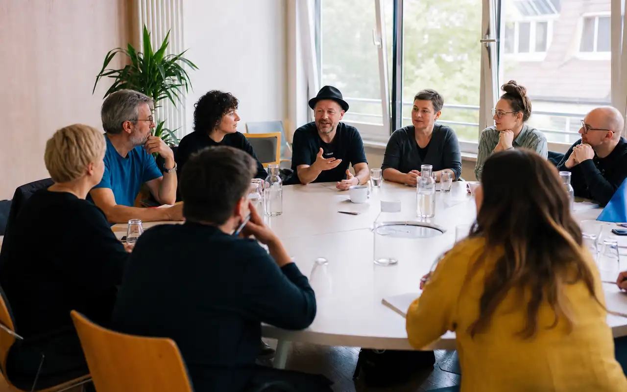 AI-generated editorial scene for Queer round table in Dachau in München